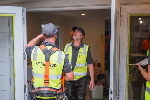 St Ferrer crew in hi-vis looking up at the work inside the doorway
