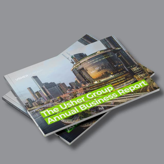 Two copies of the Usher Group Annual Business Report display a Brisbane skyline cover with bold green typography.
