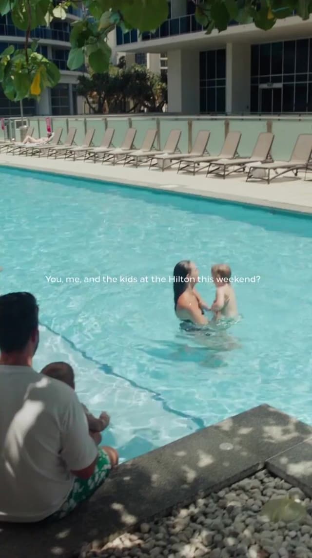 A video still shows a family at a Hilton Surfers Paradise pool, captioned about a weekend stay together.