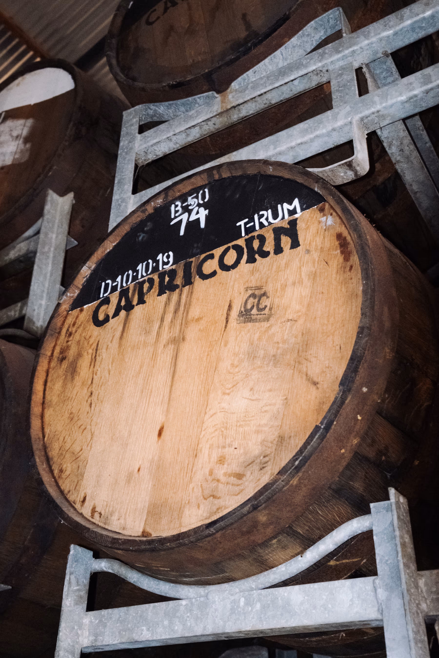 A Capricorn Distilling Co barrel head stencilled with the brand mark